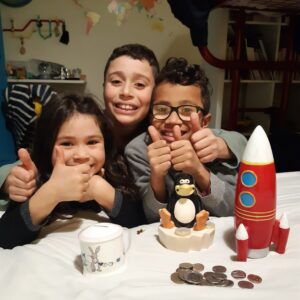 Happy Children with piggy banks infront of them