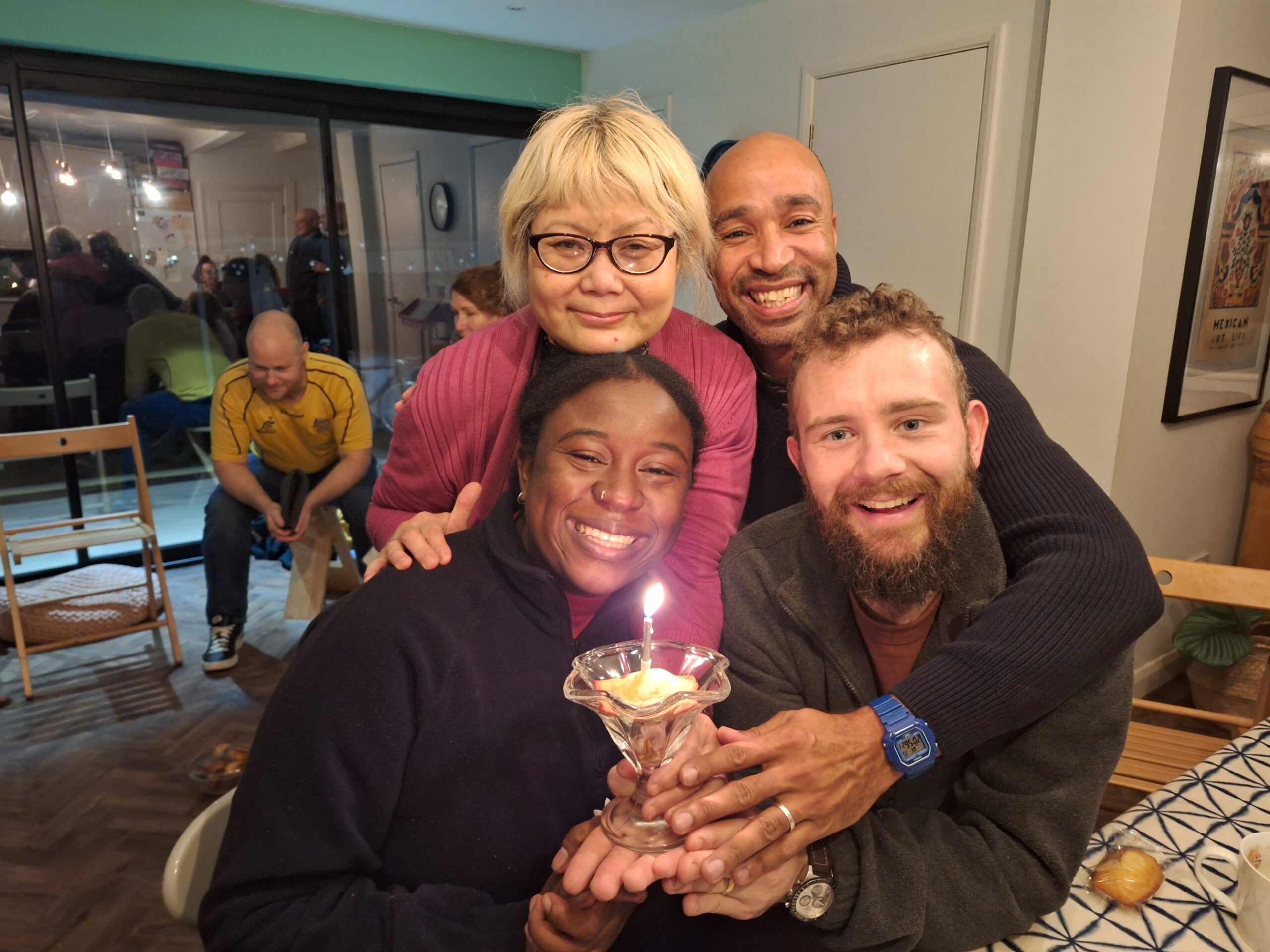 Group with a dessert with a candle in it